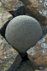 Afternoon, Muir Beach, California. Sand globe placed in a cracked boulder. I wonder if one grain of the sand globe has come from this boulder. 2007.